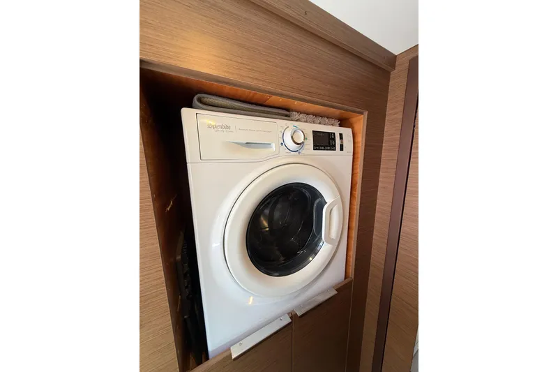 Slide: The Image of Washing machine in a 2021 Lagoon 46 yacht's wooden interior compartment. - 78