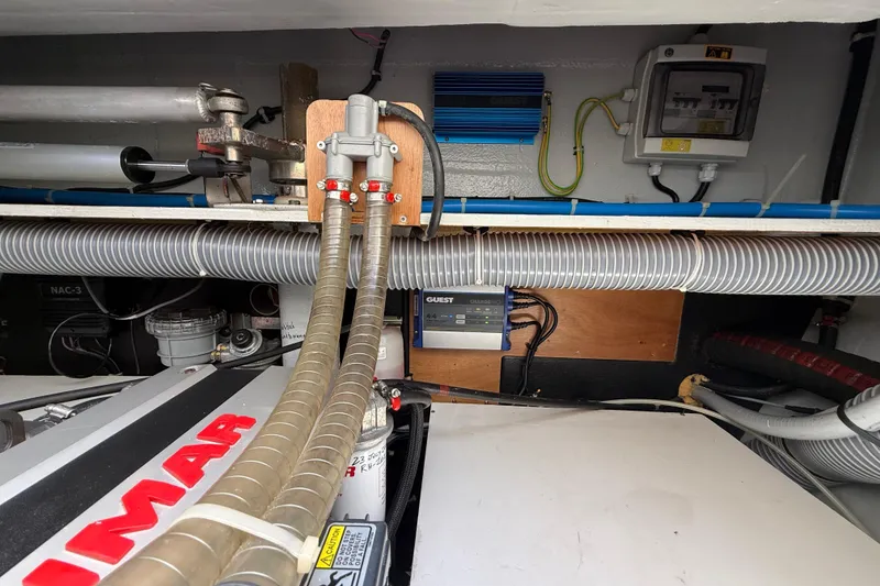 Slide: The Image of Engine room of a 2021 Lagoon 46 catamaran, featuring mechanical and electrical components. - 94