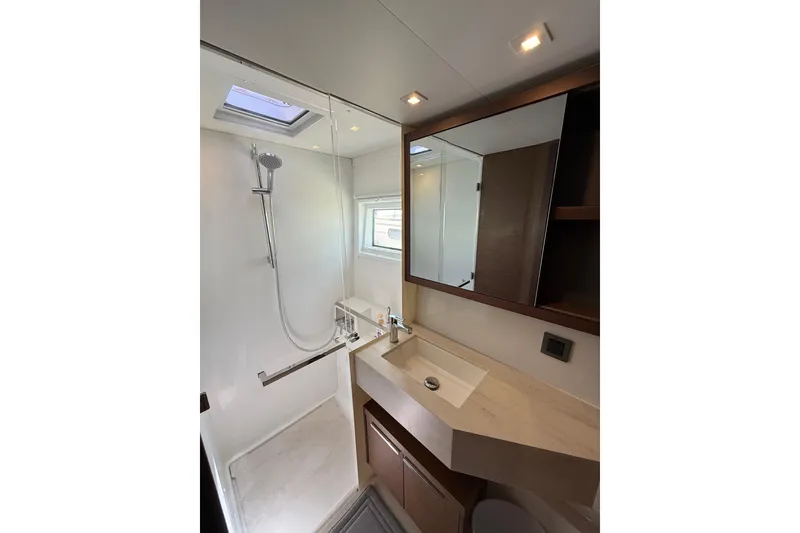 Slide: The Image of Modern bathroom in 2021 Lagoon 46 yacht with shower, sink, and mirror. - 80