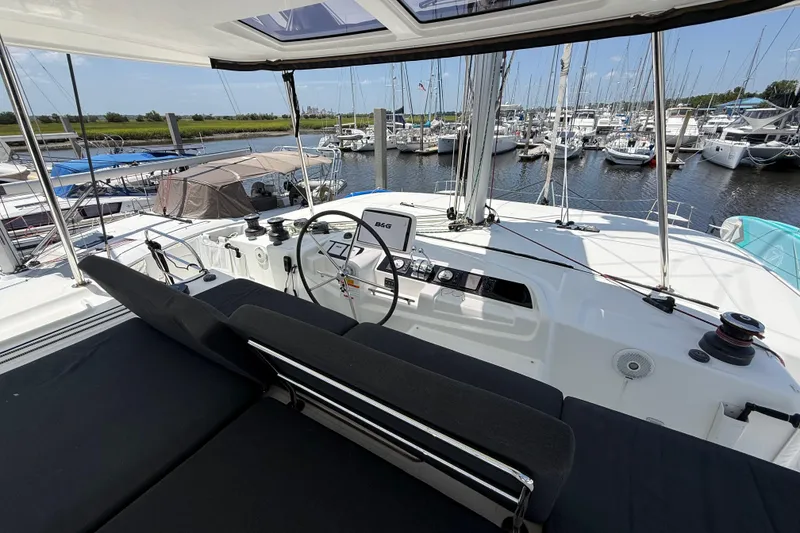 Slide: The Image of Helm of 2021 Lagoon 46 catamaran in marina, featuring modern navigation equipment. - 18