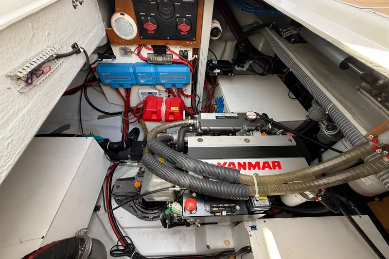 Slide: The Image of Engine room of a 2021 Lagoon 46 catamaran featuring a Yanmar engine and electrical components. - 96