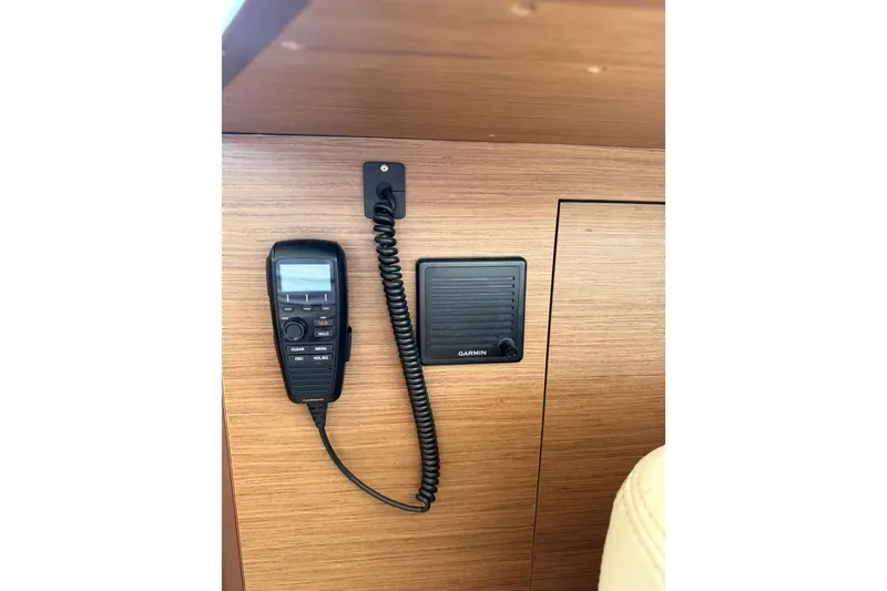 Slide: The Image of VHF radio and Garmin speaker on Lagoon 46 yacht, 2021 model, wooden interior. - 57
