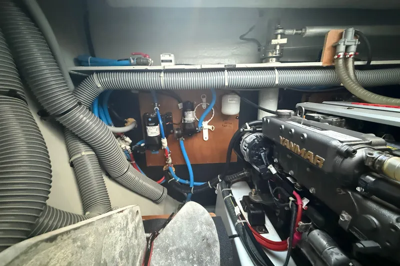 Slide: The Image of Engine room of a 2021 Lagoon 46 yacht, featuring Yanmar engine and complex piping system. - 89