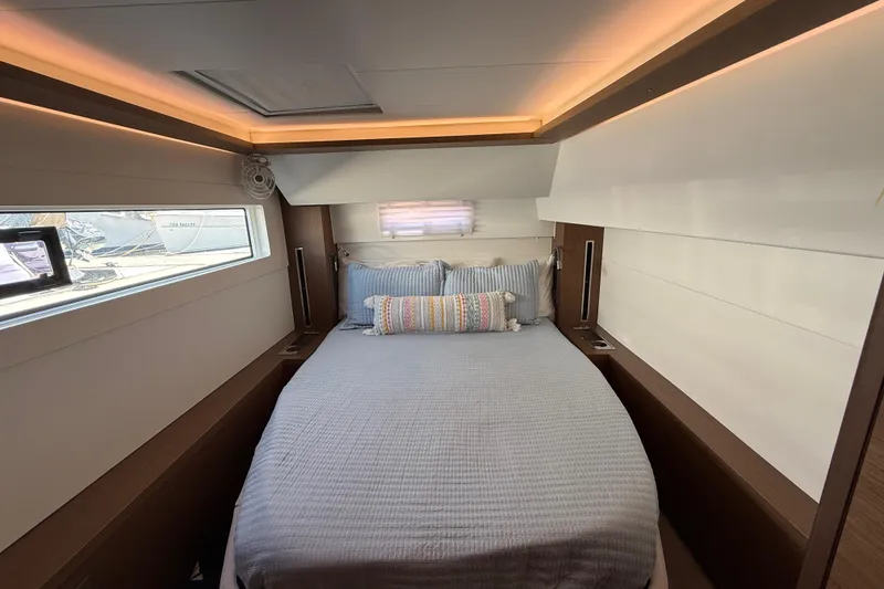 Slide: The Image of Luxurious cabin interior of 2021 Lagoon 46 yacht with cozy bedding and ambient lighting. - 74