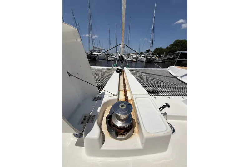 Slide: The Image of Lagoon 46 catamaran deck view, 2021 model, docked at marina under clear blue sky. - 98