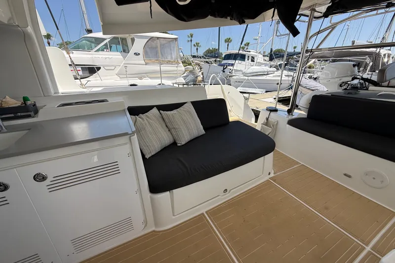 Slide: The Image of Interior of 2021 Lagoon 46 yacht with black seating and marina view. - 37