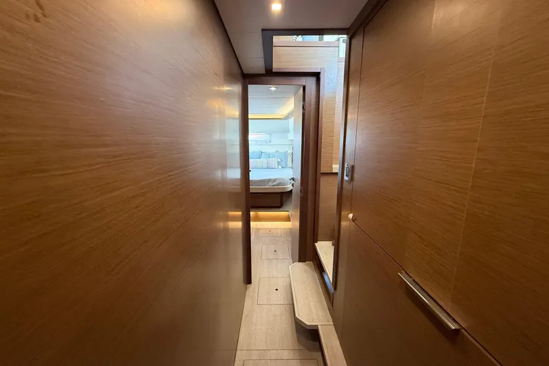 Slide: The Image of Hallway view inside 2021 Lagoon 46 yacht, leading to a cozy bedroom. - 67