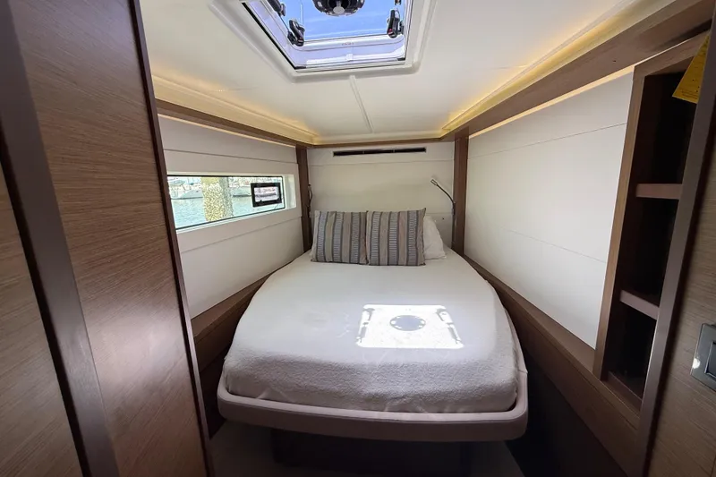 Slide: The Image of Luxurious cabin interior of 2021 Lagoon 46 yacht with cozy bed and window view. - 77