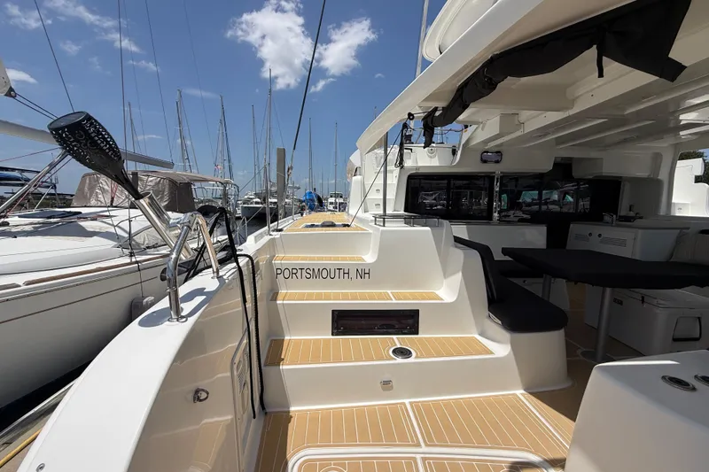 Slide: The Image of 2021 Lagoon 46 catamaran docked in Portsmouth, NH marina under clear blue skies. - 11