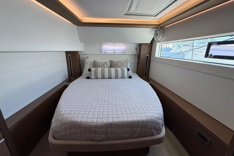 Slide: The Image of Luxurious bedroom interior of 2021 Lagoon 46 yacht with modern design and cozy bedding. - 84