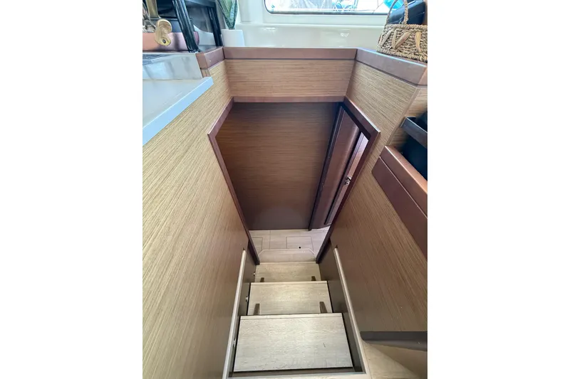 Slide: The Image of Interior stairs of 2021 Lagoon 46 yacht, featuring wooden finish and compact design. - 75