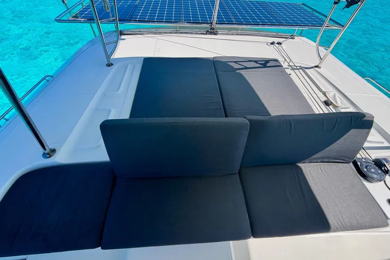 Slide: The Image of Luxurious Lagoon 46 catamaran deck with solar panels and comfortable seating, 2021 model. - 15
