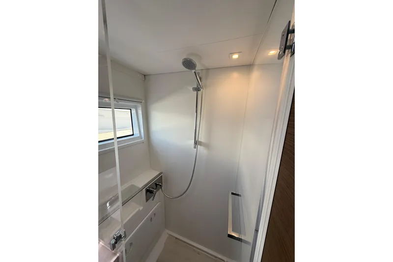 Slide: The Image of Modern shower area in 2021 Lagoon 46 yacht with sleek fixtures and window. - 65