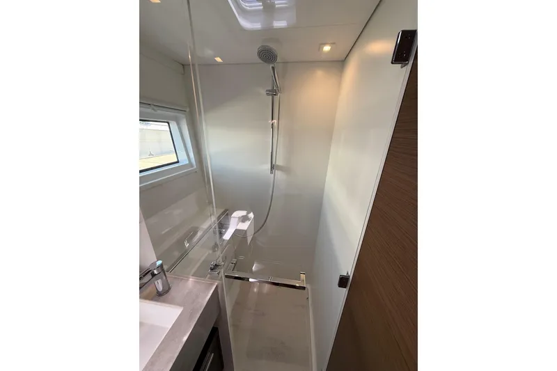 Slide: The Image of Modern shower area in 2021 Lagoon 46 yacht, featuring sleek design and glass enclosure. - 64