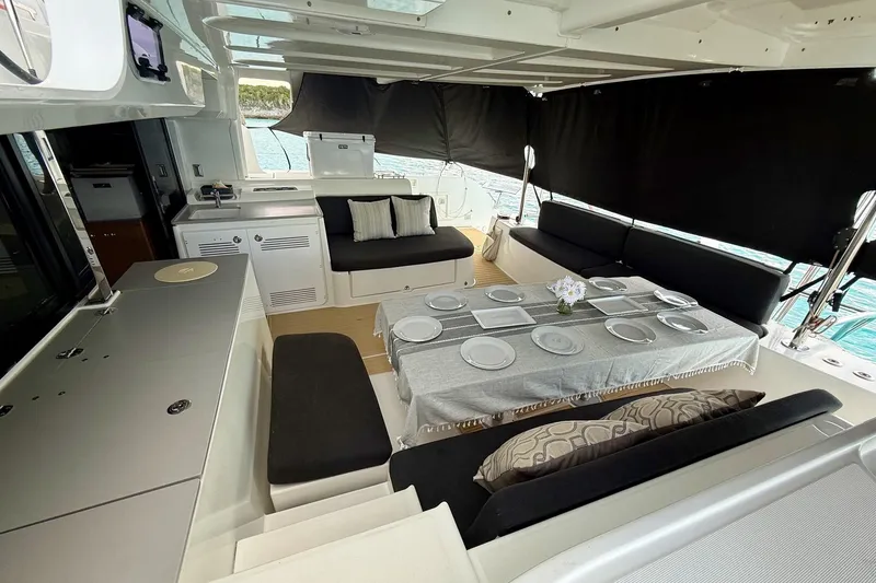 Slide: The Image of Luxurious Lagoon 46 catamaran interior, 2021 model, featuring elegant dining setup and modern amenities. - 33