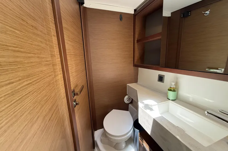 Slide: The Image of Modern bathroom interior on a 2021 Lagoon 46 yacht, featuring wood accents and sleek fixtures. - 66