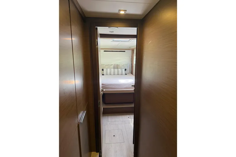 Slide: The Image of Interior view of a 2021 Lagoon 46 yacht cabin with modern wood finish. - 59