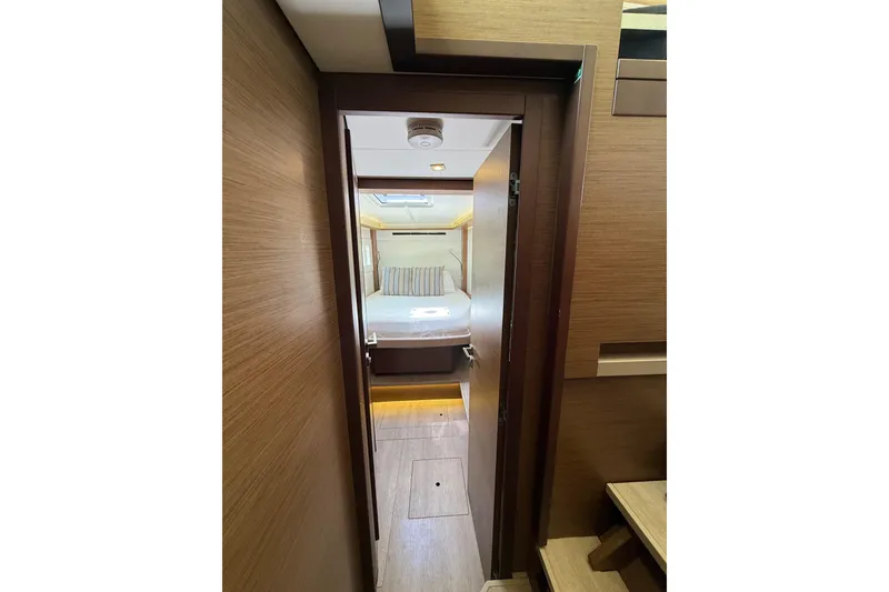Slide: The Image of Interior view of a 2021 Lagoon 46 yacht cabin with modern wood finish. - 76