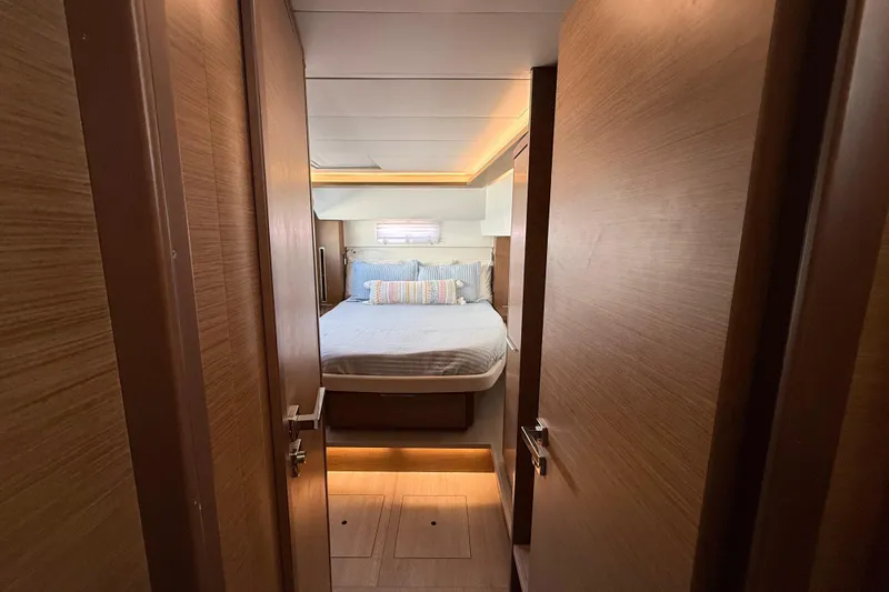 Slide: The Image of Interior cabin of 2021 Lagoon 46 yacht with cozy bed and wooden finish. - 68