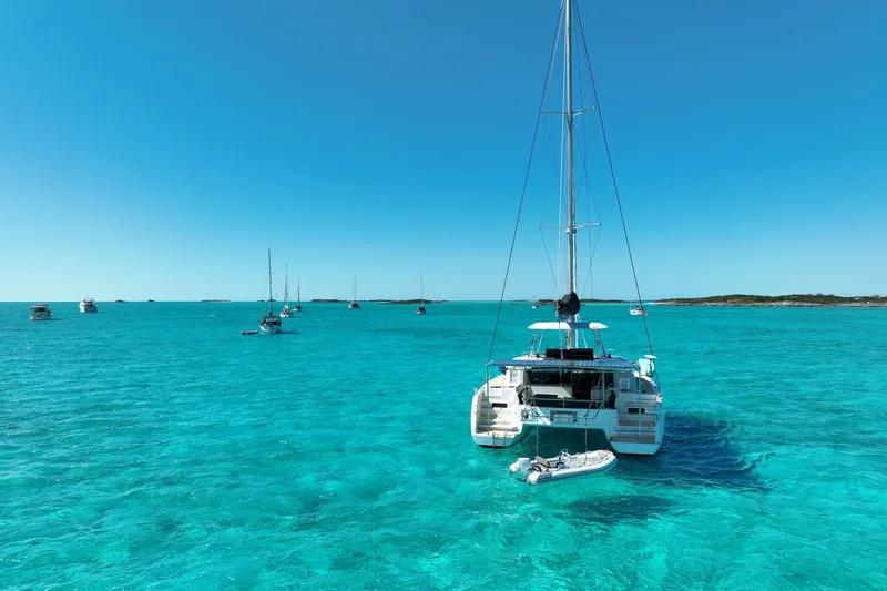 Slide: The Image of Lagoon 46 catamaran sailing in clear turquoise waters, 2021 model. - 4