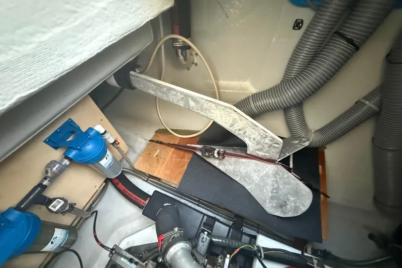 Slide: The Image of Interior view of a 2021 Lagoon 46 yacht's mechanical compartment with anchor and hoses. - 91
