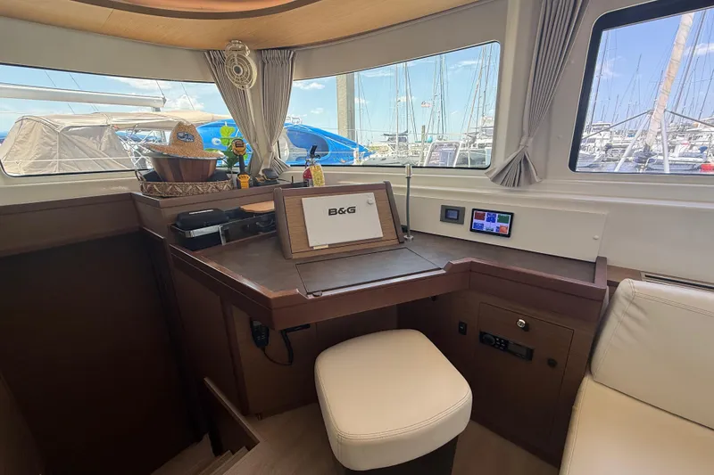 Slide: The Image of Interior of 2021 Lagoon 46 yacht with navigation station and marina view. - 53