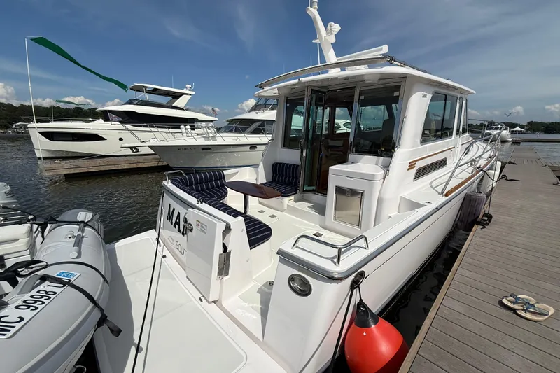 Slide: The Image of 2013 Sabre 42 Salon Express yacht docked at marina, featuring sleek design and spacious deck. - 11