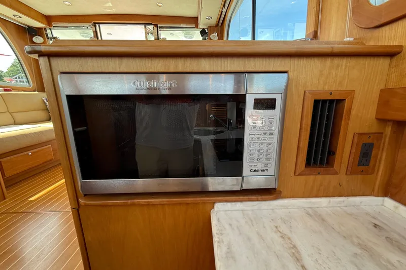 Slide: The Image of Cuisinart microwave in 2013 Sabre 42 Salon Express yacht interior, featuring wood cabinetry. - 58
