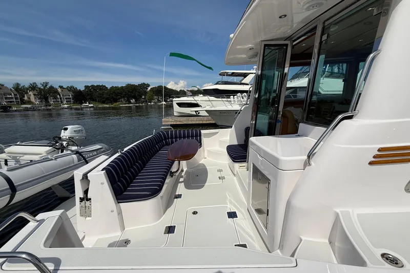 Slide: The Image of 2013 Sabre 42 Salon Express yacht with elegant seating and sleek design at a marina. - 13