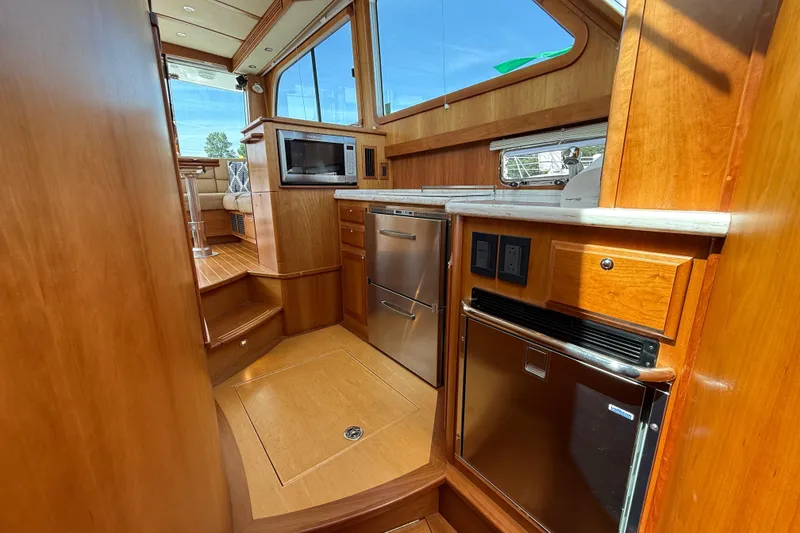 Slide: The Image of Luxurious 2013 Sabre 42 Salon Express yacht interior with modern kitchen amenities and wooden finishes. - 55