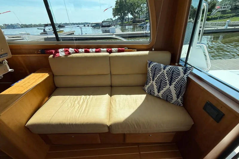 Slide: The Image of Interior of 2013 Sabre 42 Salon Express with beige seating and decorative pillow. - 37