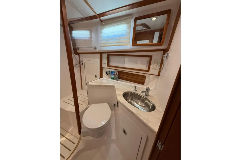 Slide: The Image of Bathroom interior of 2013 Sabre 42 Salon Express yacht, featuring sink and toilet. - 69