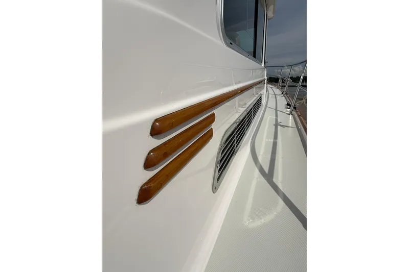 Slide: The Image of 2013 Sabre 42 Salon Express yacht with sleek wooden accents and side deck view. - 81