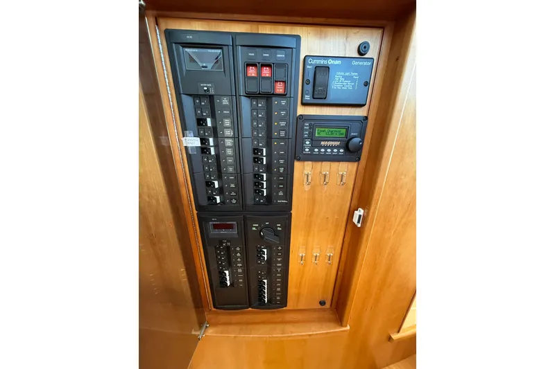 Slide: The Image of Electrical panel of 2013 Sabre 42 Salon Express yacht with Cummins Onan generator controls. - 49