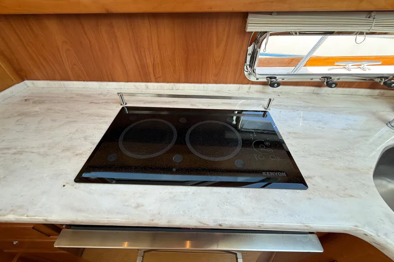 Slide: The Image of Modern kitchen cooktop on 2013 Sabre 42 Salon Express yacht with marble countertop. - 57