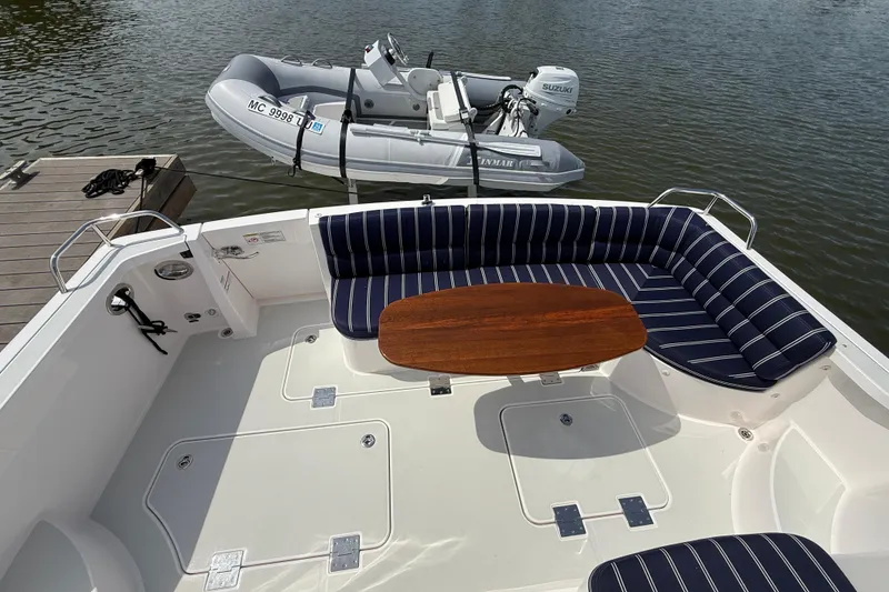 Slide: The Image of 2013 Sabre 42 Salon Express yacht with striped seating and wooden table on deck. - 15
