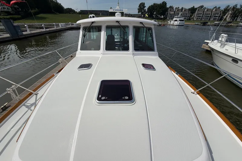 Slide: The Image of 2013 Sabre 42 Salon Express yacht docked at marina, showcasing sleek deck design. - 21