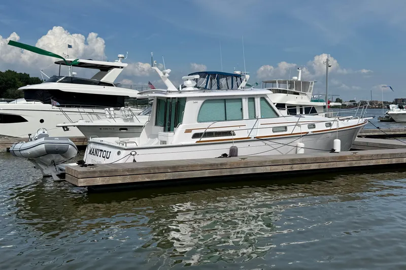 Slide: The Image of 2013 Sabre 42 Salon Express yacht docked at marina under clear skies. - 8