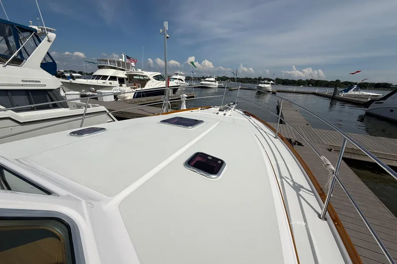 Slide: The Image of 2013 Sabre 42 Salon Express yacht docked at marina under clear sky. - 22