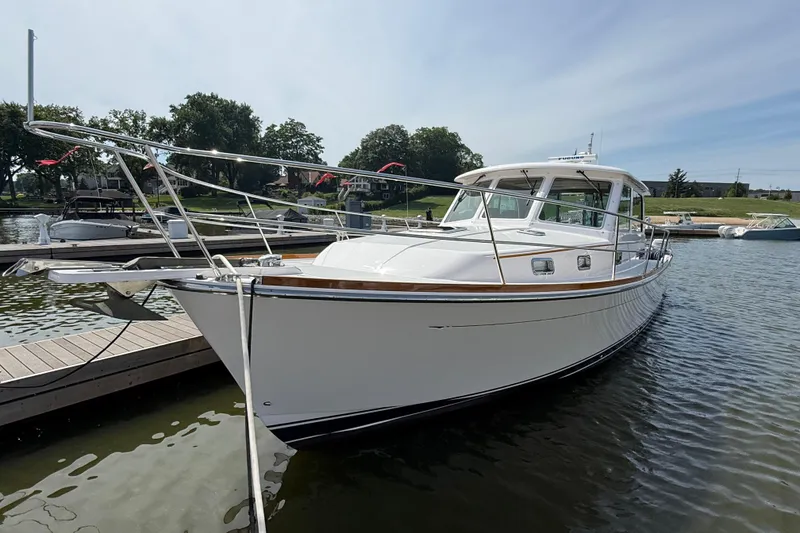 Slide: The Image of 2013 Sabre 42 Salon Express yacht docked on calm water, showcasing sleek design and elegance. - 3
