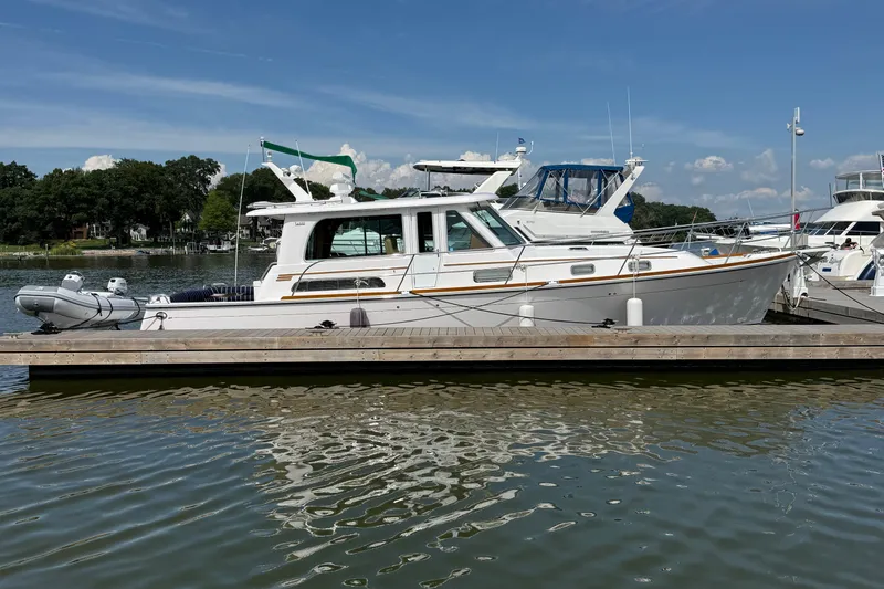 Slide: The Image of 2013 Sabre 42 Salon Express yacht docked at marina on a sunny day. - 7