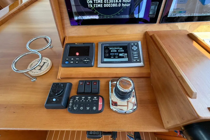 Slide: The Image of Control panel of a 2013 Sabre 42 Salon Express with navigation and throttle controls. - 45