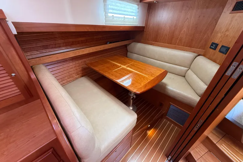 Slide: The Image of Interior of 2013 Sabre 42 Salon Express with wooden dining area and beige seating. - 62