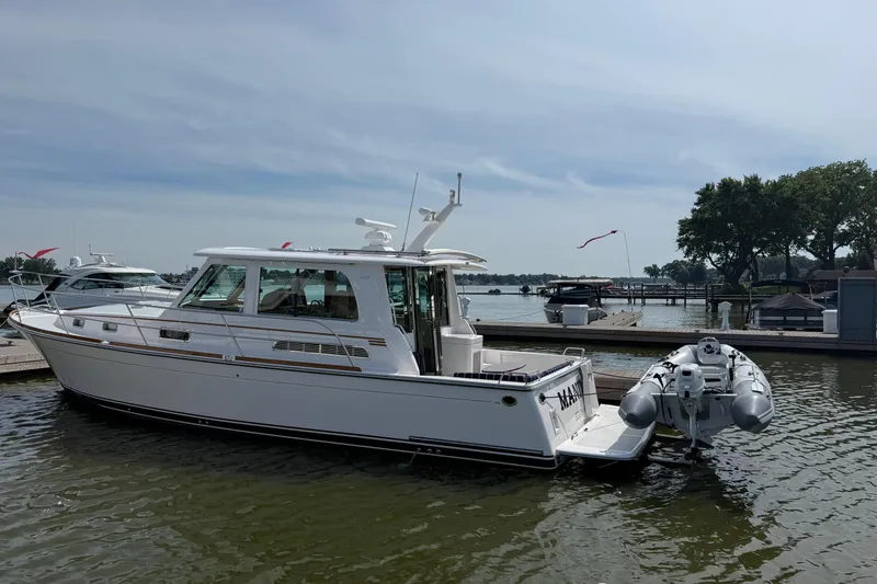Slide: The Image of 2013 Sabre 42 Salon Express yacht docked at a marina on a sunny day. - 4