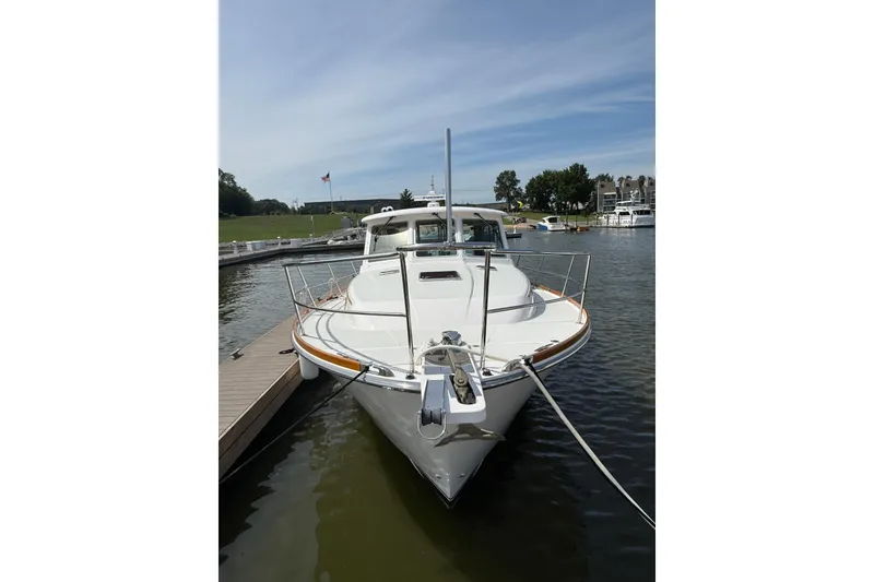 Slide: The Image of 2013 Sabre 42 Salon Express yacht docked at marina, front view. - 9