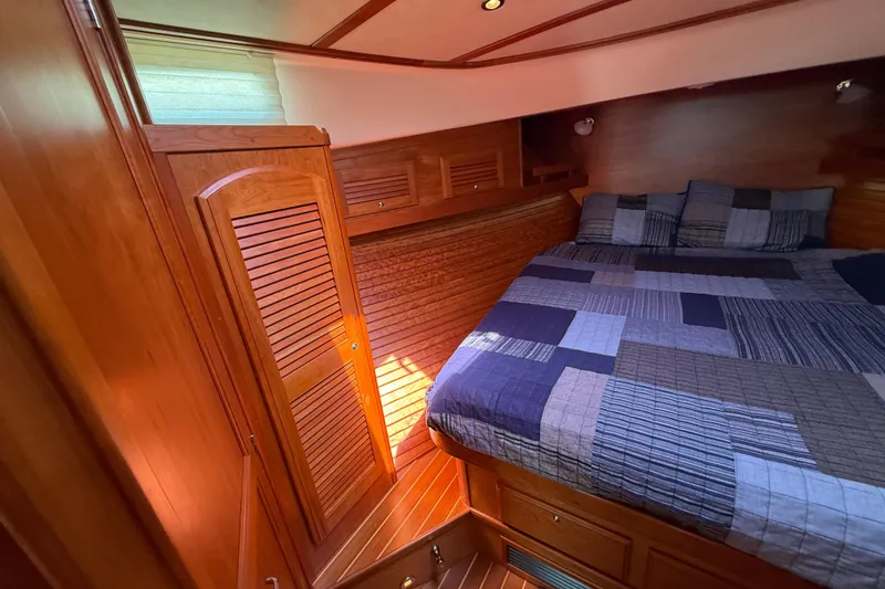 Slide: The Image of Luxurious 2013 Sabre 42 Salon Express cabin with wood paneling and cozy bedding. - 61