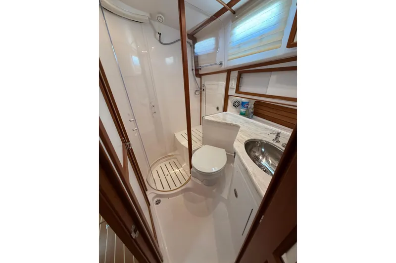 Slide: The Image of Bathroom interior of 2013 Sabre 42 Salon Express yacht, featuring shower, toilet, and sink. - 68