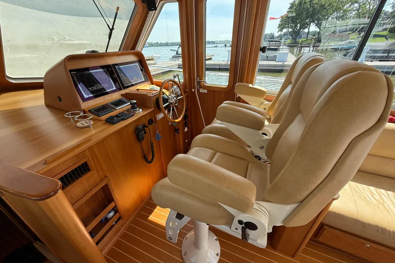 Slide: The Image of Interior of 2013 Sabre 42 Salon Express yacht with helm and plush seating. - 43