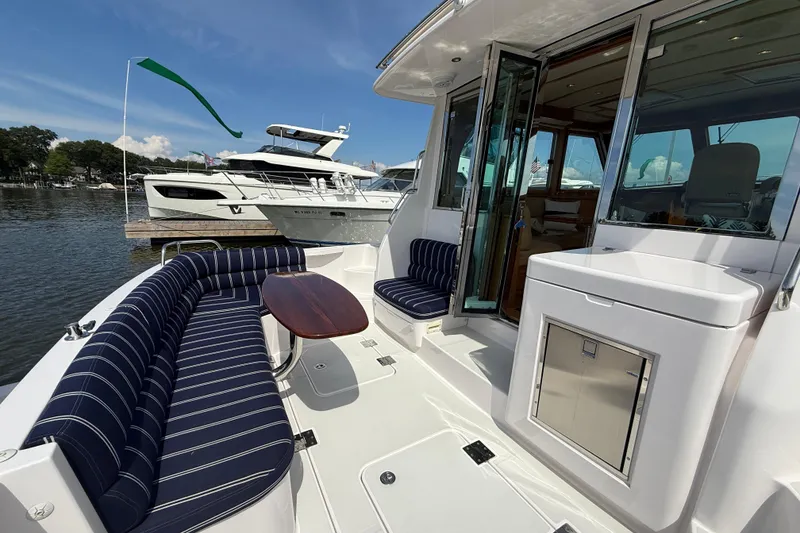 Slide: The Image of 2013 Sabre 42 Salon Express yacht with elegant seating and sleek design on a sunny day. - 12