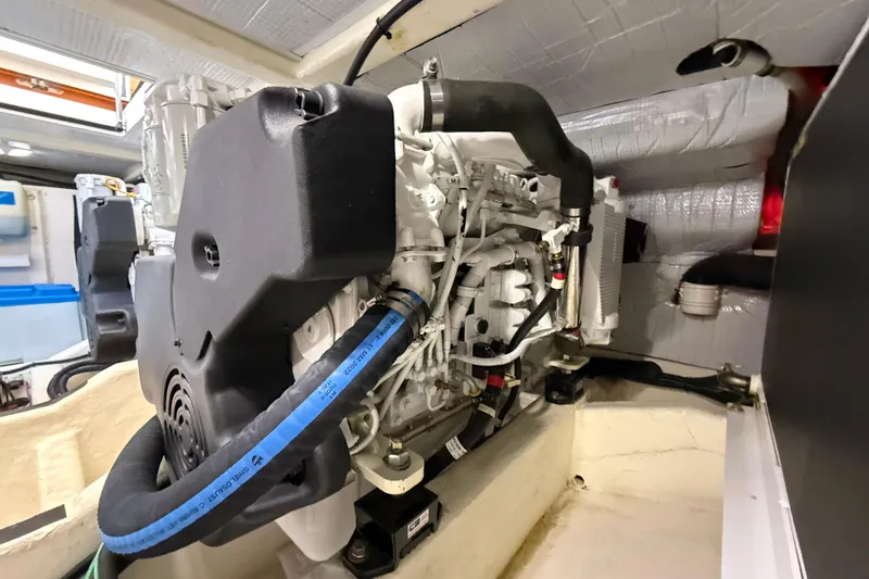 Slide: The Image of Engine room of a 2013 Sabre 42 Salon Express, showcasing detailed mechanical components. - 74